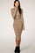 woman wearing a beige ribbed long sleeve midi dress and black ankle boots