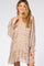 smiling woman wearing a long sleeve floral print maternity dress with ruffle details