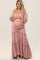 smiling pregnant woman wearing a pink off-the-shoulder tiered maternity maxi dress