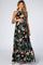 pregnant woman wearing a navy blue floral halter neck maternity maxi dress with orange hibiscus print