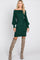 woman wearing a green off-shoulder ribbed sweater dress with balloon sleeves and knee-high beige boots