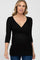 woman wearing a black maternity top with a wrap style and three-quarter sleeves, showing a baby bump