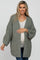 woman wearing a cozy olive green maternity cardigan and holding her baby bump