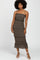 woman wearing a black floral tiered midi dress with spaghetti straps and ruffle hemdetails