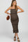 woman wearing a brown floral maternity dress with ruffles and spaghetti straps, showcasing her baby bump