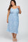 plus size woman wearing a light blue floral midi dress with spaghetti straps and a waist tie