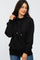woman wearing a black long sleeve hoodie with drawstrings and a front pocket