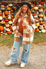 woman wearing a tan and white plaid maternity shacket, holding a drink, with visible baby bump and distressed jeans