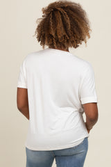 woman wearing a white short sleeve shirt viewed from the back, paired with blue jeans