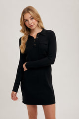 woman wearing a black ribbed long sleeve dress with a buttoned placket and a chest pocket