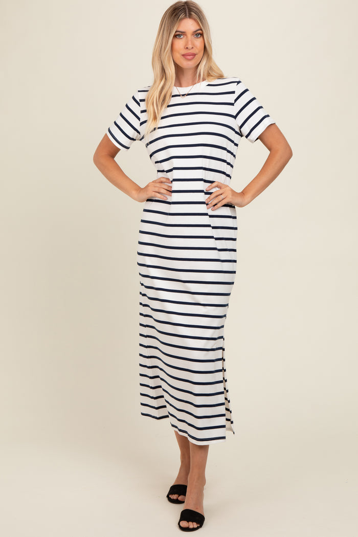 woman wearing a white and navy striped short sleeve maxi dress with a side slit and a relaxed fit