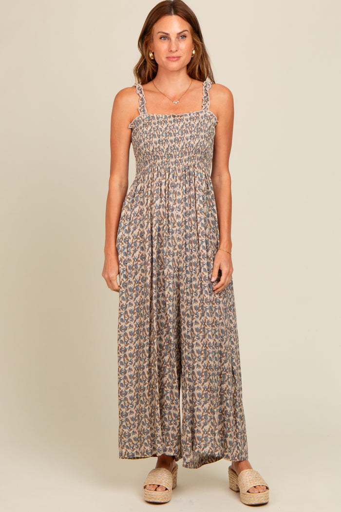 woman wearing a floral maxi dress with smocked bodice and braided straps