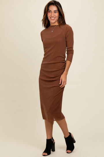 woman wearing a brown long sleeve ribbed midi dress with side ruching and black open-toe heeled shoes