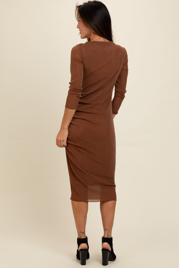 woman wearing a brown long sleeve bodycon dress, showcasing a fitted silhouette and mid-calf length
