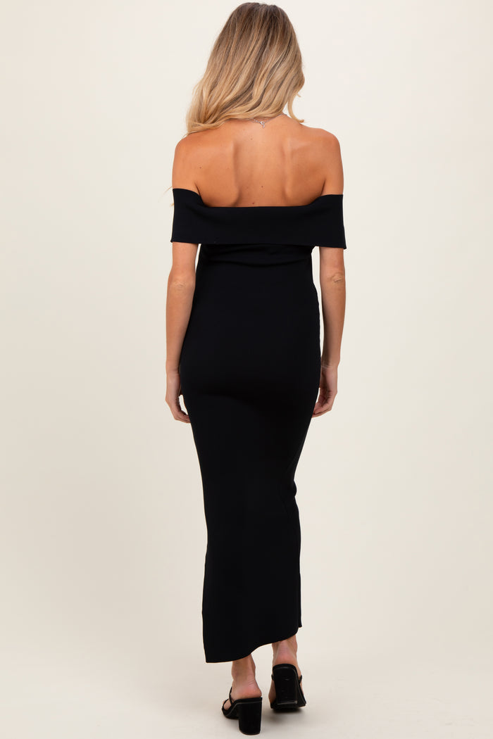 woman wearing a black off-the-shoulder maternity maxi dress, showing the back view with a fitted silhouette