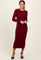 woman wearing a burgundy long sleeve ribbed midi dress and black heeled shoes