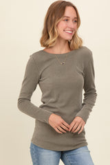 woman wearing a taupe long sleeve ribbed top with a round neckline paired with light blue jeans