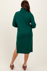 woman wearing a green oversized turtleneck sweater dress with side slits