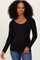 woman wearing a black long sleeve top with a scoop neckline and smiling at the camera