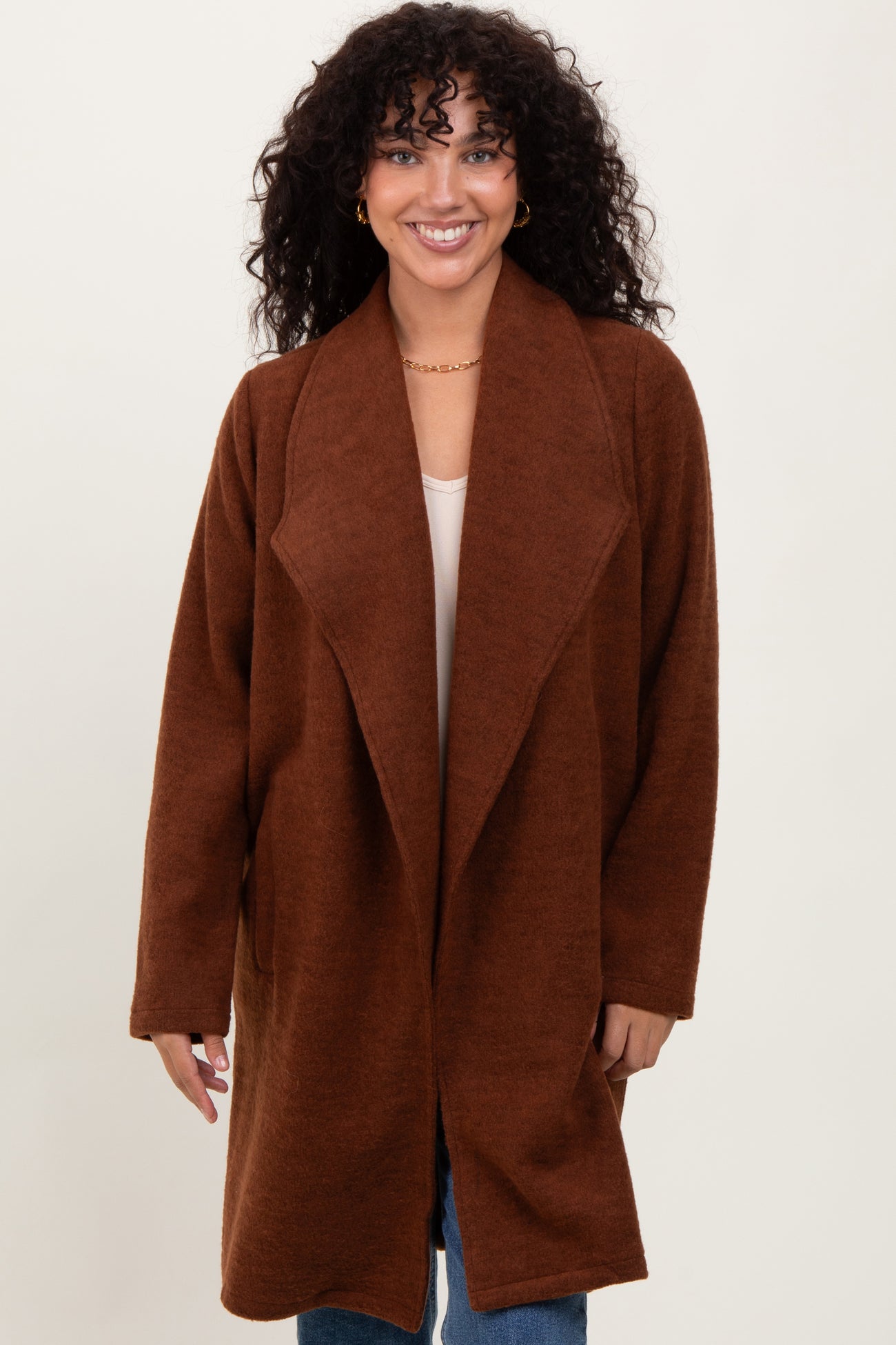 woman wearing a brown oversized cardigan with a shawl collar and long sleeves