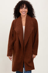woman wearing a brown oversized cardigan with a shawl collar and long sleeves