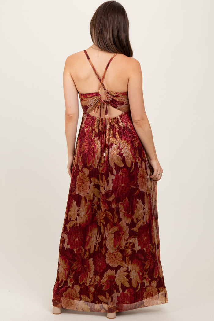 woman wearing a burgundy floral maternity maxi dress with a crisscross back design and gathered waist