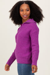 woman wearing a purple hooded knit sweater with a front zipper and ribbed cuffs, smiling at the camera