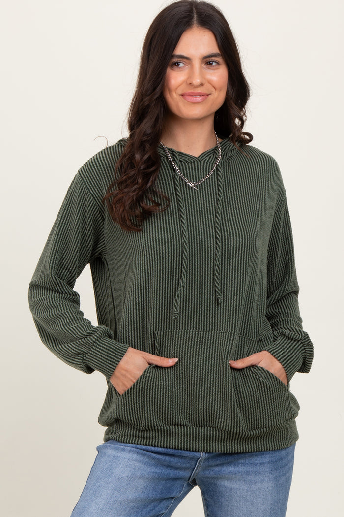 woman wearing a green striped long sleeve hoodie with a front pocket and drawstring, styled with blue jeans