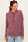 woman wearing a maroon striped pullover hoodie with a drawstring and relaxed fit