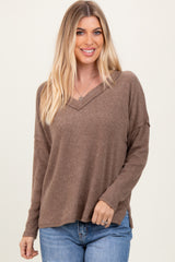 woman wearing a brown ribbed long sleeve v-neck top with relaxed fit and soft fabric