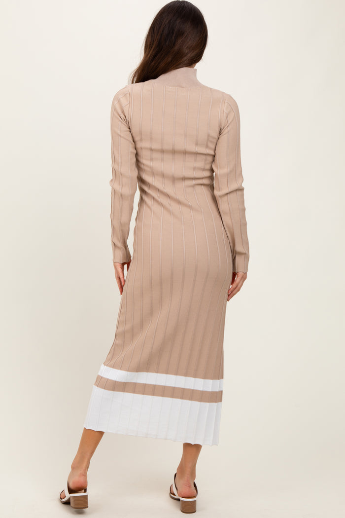 woman wearing a beige ribbed midi dress with white striped details and a fitted silhouette, seen from the back