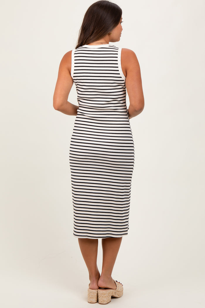 woman wearing a black and white striped maternity dress with a form-fitting design and knee-length cut