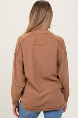 woman wearing a brown textured maternity sweater, showing the back view, with relaxed fit and long sleeves