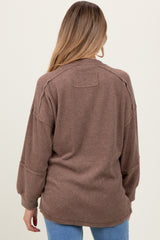 woman wearing a brown ribbed maternity sweater with a relaxed fit and dropped shoulders, seen from the back