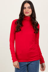 woman wearing a red long sleeve turtleneck top with fitted style and slight draping