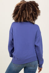 woman wearing a purple maternity sweatshirt with a relaxed fit and long sleeves, showing the back view