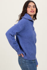 woman wearing a light purple knit pullover sweater with a folded collar and side pockets, paired with jeans