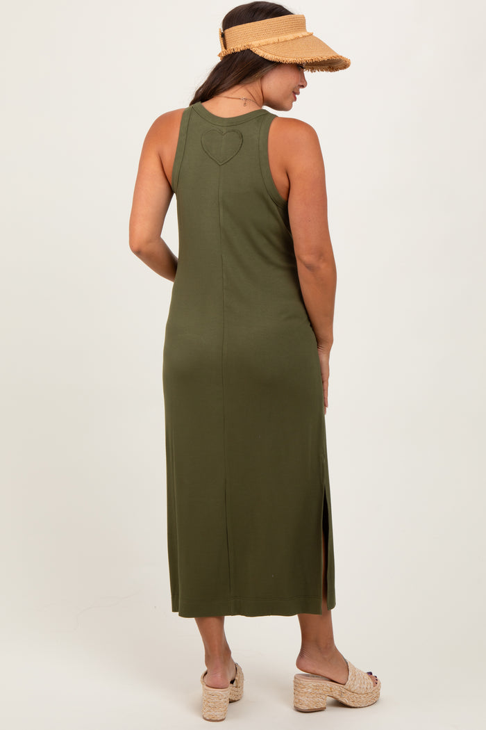 woman wearing a dark green maternity maxi dress with a heart detail on the back and side slits