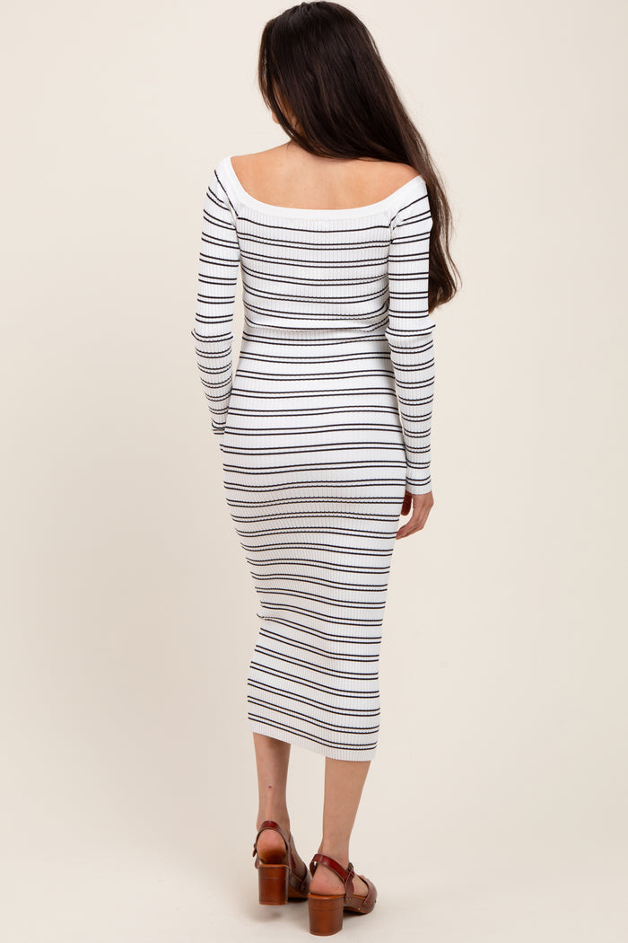 woman wearing a white and navy striped long sleeve maternity dress, showing her baby bump from the back
