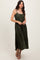woman wearing a dark olive green pleated maxi dress with spaghetti straps and a flowing silhouette