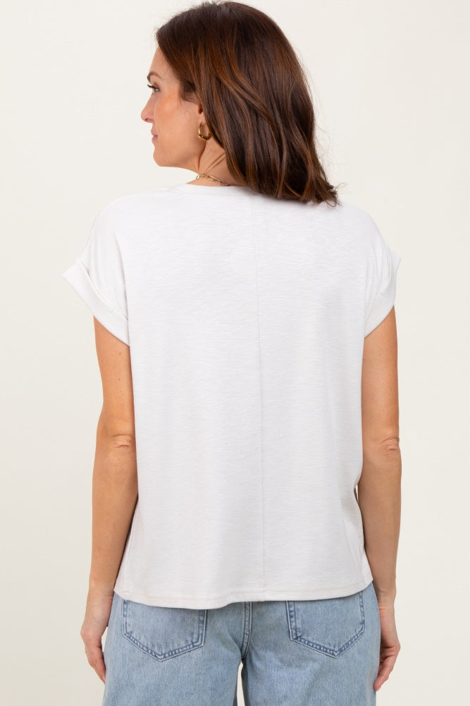 woman wearing a light gray short sleeve top with rolled cuffs, viewed from the back, paired with light blue jeans