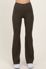 woman wearing black high-waisted flared yoga pants with a smooth finish and a fitted silhouette