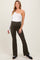 woman wearing a white one-shoulder maternity top and olive green flared maternity pants
