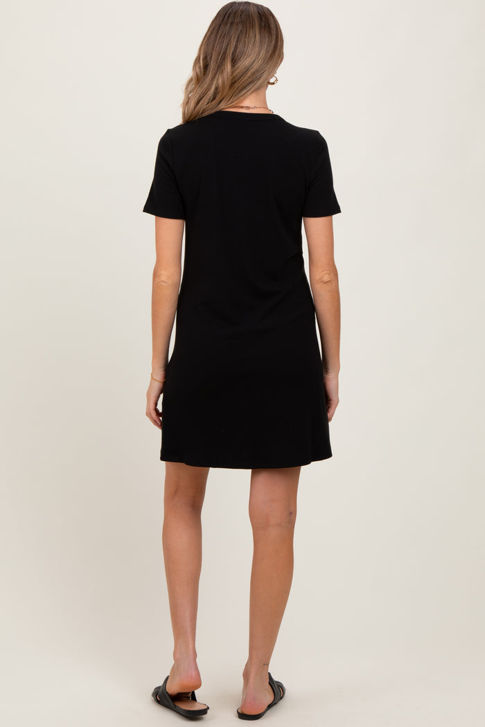 woman wearing a black short sleeve maternity dress, shown from the back