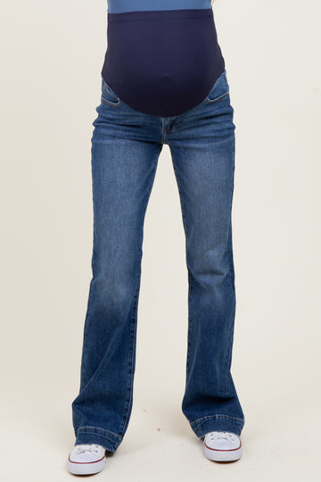 woman wearing a pair of blue maternity bootcut jeans with a supportive belly panel