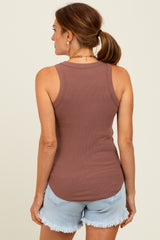 woman wearing a brown ribbed tank top and light denim shorts, seen from the back