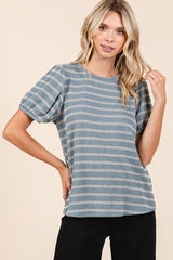 woman wearing a blue striped short sleeve top with puffed sleeves and a relaxed fit
