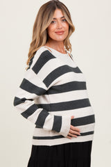 woman wearing a striped maternity sweater with a loose fit and baby bump visible
