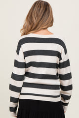 woman wearing a striped maternity sweater in cream and black, seen from the back