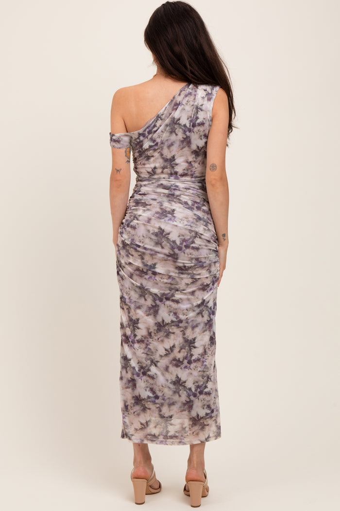woman wearing a one-shoulder purple and gray tie-dye maternity dress with a fitted silhouette
